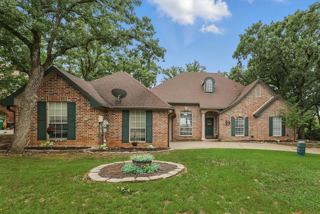 1128 Bent Oaks Dr, Denton, TX 76210 - view of front facade with brick siding, a front yard, and roof with shingles