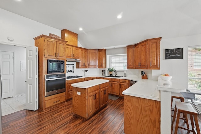 1128 Bent Oaks Dr, Denton, TX 76210 - kitchen featuring oven, black microwave, gas cooktop, lofted ceiling, and a peninsula