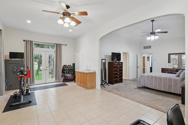 1128 Bent Oaks Dr, Denton, TX 76210 - bedroom with arched walkways, french doors, light tile patterned floors, light colored carpet, and recessed lighting