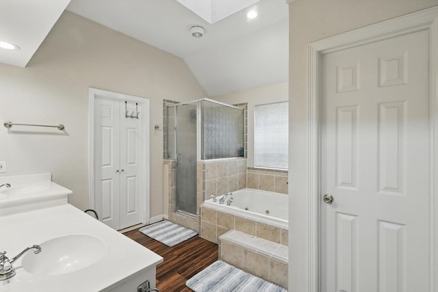 1128 Bent Oaks Dr, Denton, TX 76210 - bathroom featuring a shower stall, a tub with jets, a skylight, double vanity, and wood finished floors