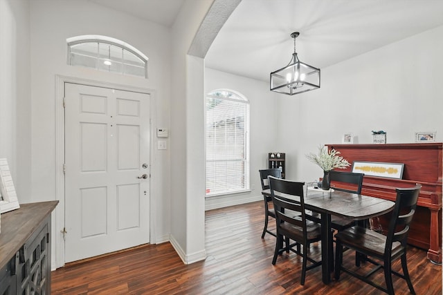 1128 Bent Oaks Dr, Denton, TX 76210 - dining space featuring a chandelier, dark wood-type flooring, and arched walkways