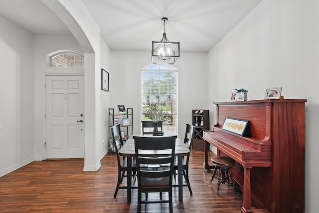 1128 Bent Oaks Dr, Denton, TX 76210 - dining area featuring dark wood-style flooring, arched walkways, and a chandelier