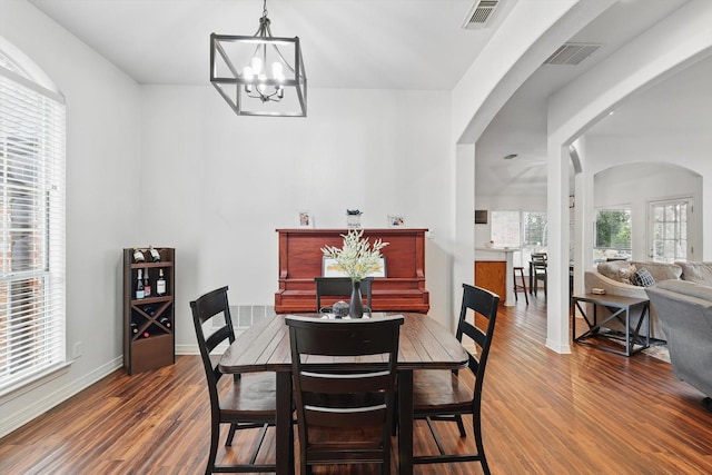 1128 Bent Oaks Dr, Denton, TX 76210 - dining area featuring arched walkways, wood finished floors, and a chandelier