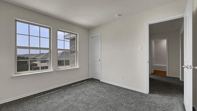 414 Drake Dr, Ferris, TX 75125 - empty room with dark carpet, attic access, and a smoke detector