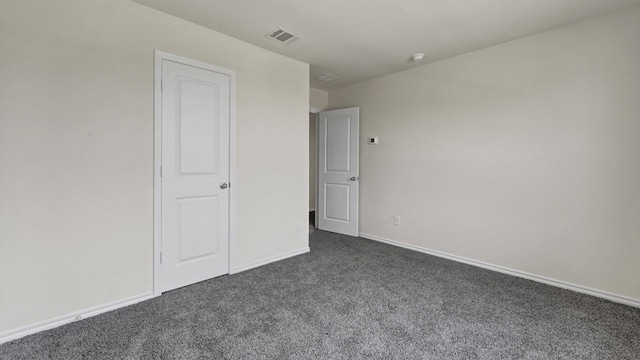 414 Drake Dr, Ferris, TX 75125 - unfurnished bedroom with dark colored carpet and baseboards