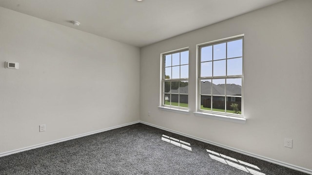 414 Drake Dr, Ferris, TX 75125 - empty room with baseboards and dark carpet