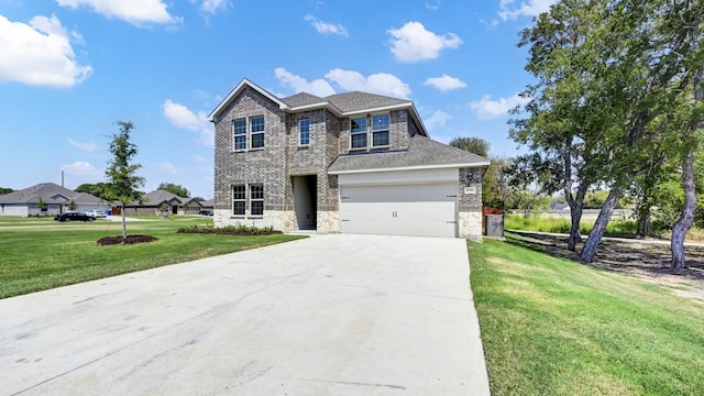 414 Drake Dr, Ferris, TX 75125 - traditional home featuring concrete driveway, stone siding, a front yard, and roof with shingles