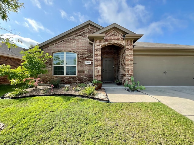 1092 Decker Dr, Fate, TX 75189 - view of front of house with brick siding, a garage, concrete driveway, and a front lawn