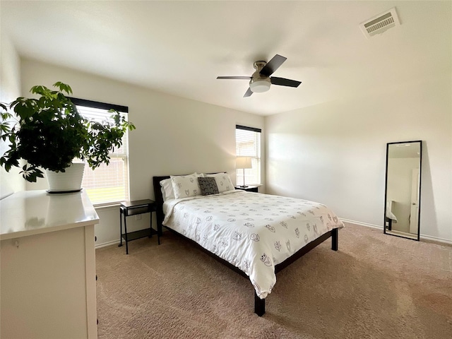 1092 Decker Dr, Fate, TX 75189 - bedroom with multiple windows, light carpet, and a ceiling fan