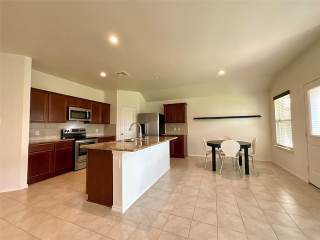 1092 Decker Dr, Fate, TX 75189 - kitchen featuring stainless steel appliances, tasteful backsplash, recessed lighting, an island with sink, and light tile patterned flooring