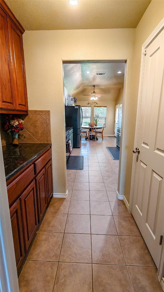 8901 Arbor Crest Ct, Fort Worth, TX 76179 - corridor featuring lofted ceiling, light tile patterned flooring, and a textured ceiling