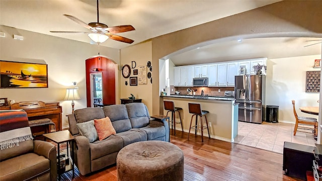 8901 Arbor Crest Ct, Fort Worth, TX 76179 - living area with ceiling fan, arched walkways, and light wood-style floors