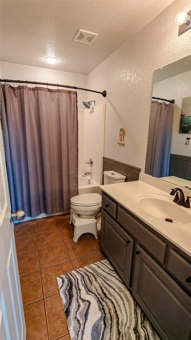 8901 Arbor Crest Ct, Fort Worth, TX 76179 - bathroom featuring a textured ceiling, vanity, tile patterned flooring, a textured wall, and shower / bathtub combination with curtain