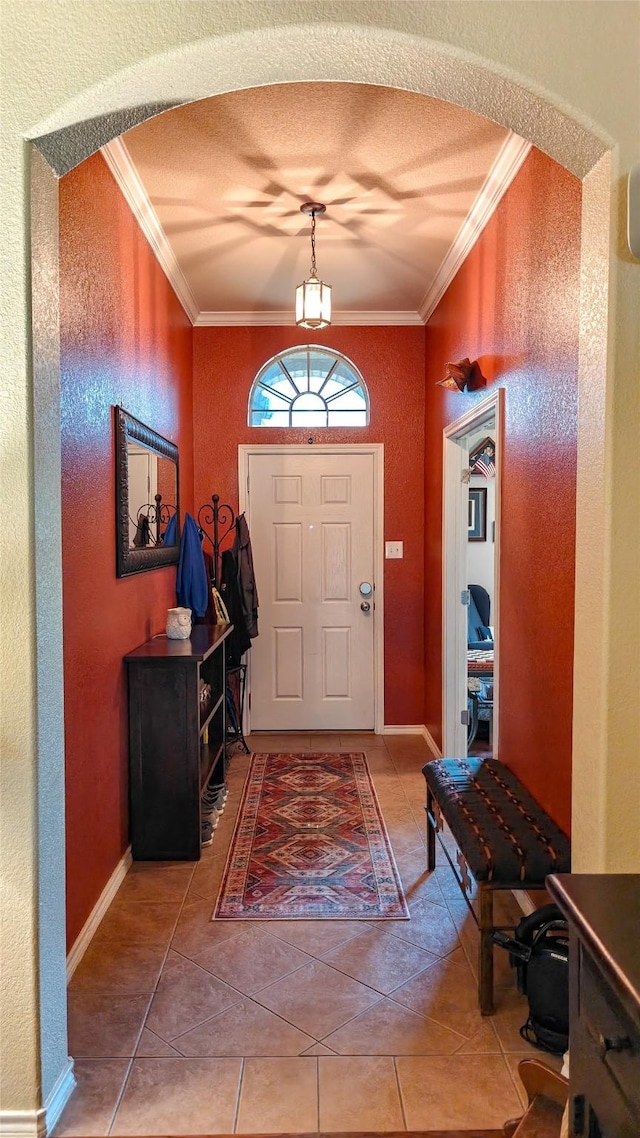 8901 Arbor Crest Ct, Fort Worth, TX 76179 - foyer with ornamental molding, tile patterned flooring, a textured wall, and arched walkways