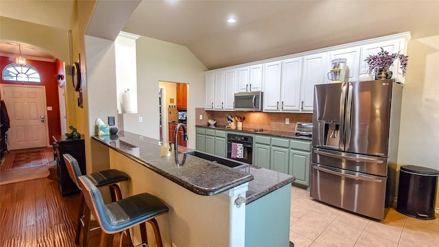 8901 Arbor Crest Ct, Fort Worth, TX 76179 - kitchen featuring black appliances, white cabinets, lofted ceiling, backsplash, and a peninsula