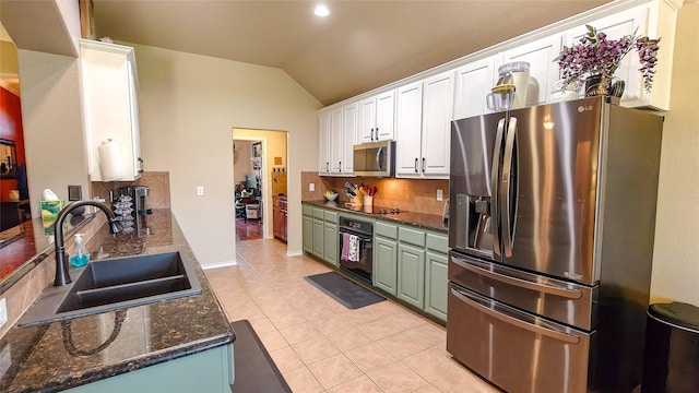 8901 Arbor Crest Ct, Fort Worth, TX 76179 - kitchen featuring black appliances, backsplash, vaulted ceiling, white cabinets, and light tile patterned flooring