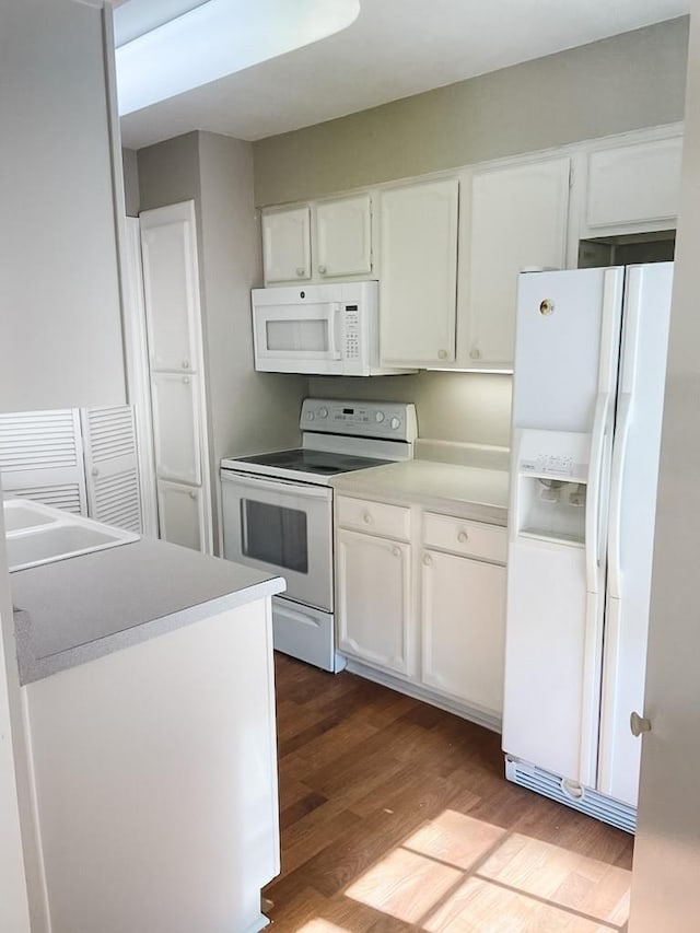3101 Townbluff Dr Unit 822, Plano, TX 75075 - kitchen featuring white appliances, white cabinets, and wood finished floors