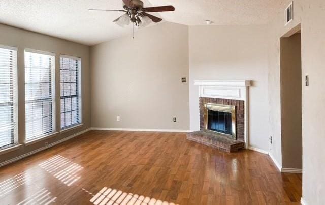 3101 Townbluff Dr Unit 822, Plano, TX 75075 - unfurnished living room featuring a ceiling fan, wood finished floors, a fireplace, and vaulted ceiling