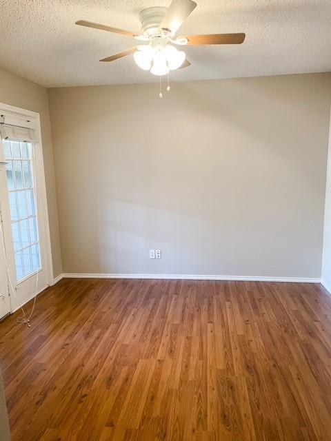 3101 Townbluff Dr Unit 822, Plano, TX 75075 - empty room with wood finished floors, ceiling fan, and a textured ceiling