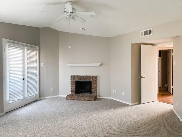 3101 Townbluff Dr Unit 822, Plano, TX 75075 - unfurnished living room with carpet floors, a ceiling fan, a fireplace, and vaulted ceiling