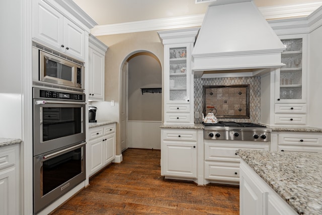 126 Yorkshire Dr, Heath, TX 75032 - kitchen featuring premium range hood, stainless steel appliances, white cabinetry, glass insert cabinets, and dark wood-style floors