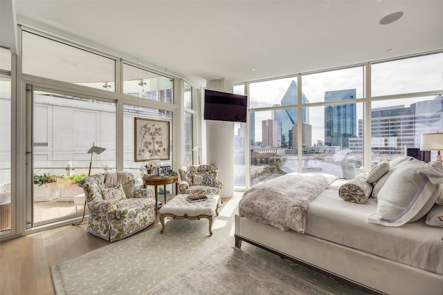 1918 Olive St Unit 502, Dallas, TX 75201 - bedroom featuring a wall of windows and wood finished floors