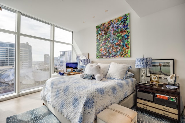 1918 Olive St Unit 502, Dallas, TX 75201 - bedroom with wood finished floors and floor to ceiling windows