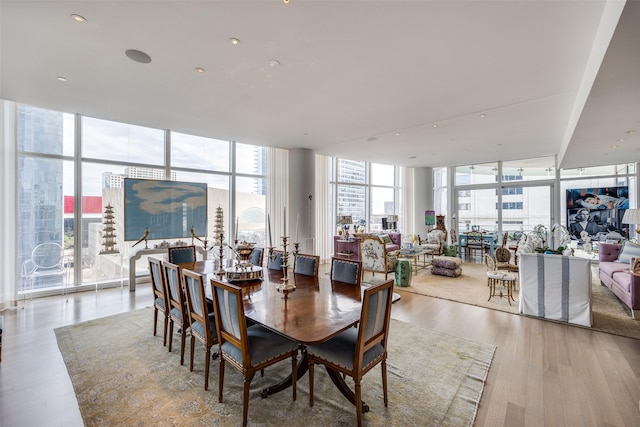 1918 Olive St Unit 502, Dallas, TX 75201 - dining room featuring a wall of windows, healthy amount of natural light, and wood finished floors