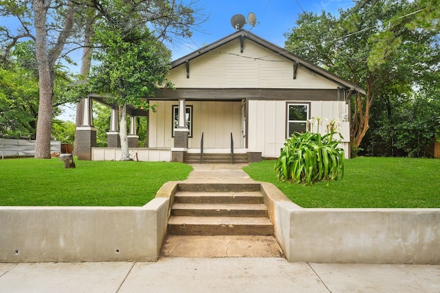 3920 Jamaica St, Dallas, TX 75210 - view of front of property with covered porch, board and batten siding, and a front lawn