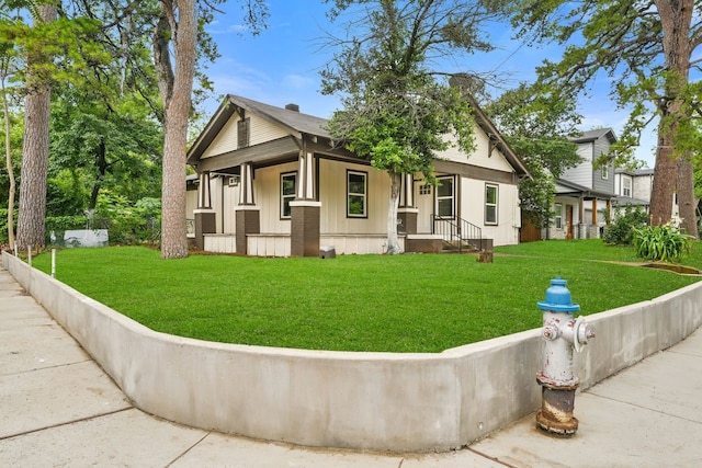 3920 Jamaica St, Dallas, TX 75210 - view of front of property with a front yard, a porch, and board and batten siding
