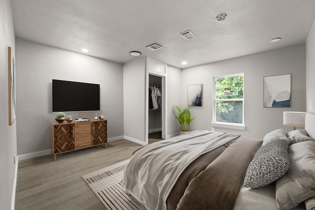 3920 Jamaica St, Dallas, TX 75210 - bedroom with light wood-style flooring and recessed lighting