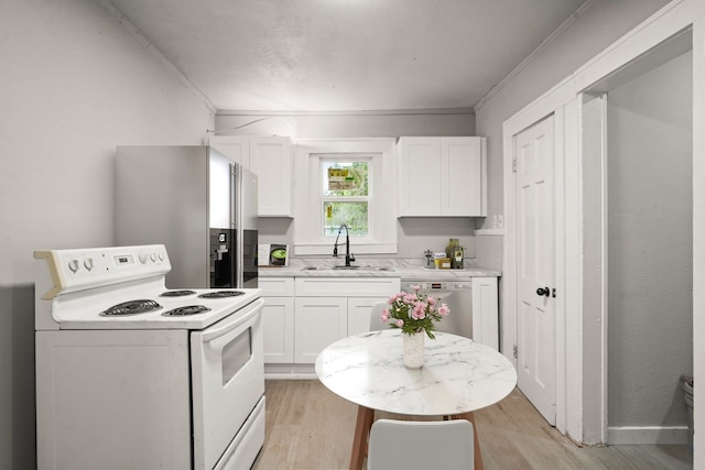 3920 Jamaica St, Dallas, TX 75210 - kitchen with appliances with stainless steel finishes, light wood-style floors, white cabinets, light countertops, and crown molding