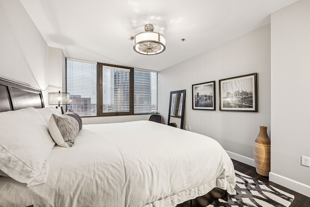 1200 Main St Unit 1106, Dallas, TX 75202 - bedroom featuring dark wood-style floors and baseboards