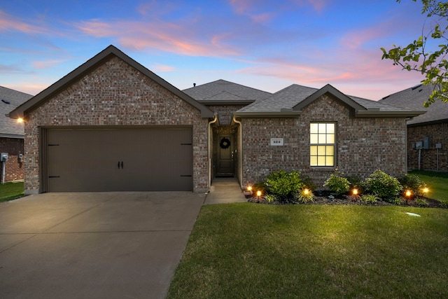 523 Summit Pass Ln, Princeton, TX 75407 - french country home with a garage, driveway, a lawn, roof with shingles, and brick siding