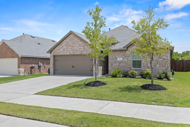 523 Summit Pass Ln, Princeton, TX 75407 - view of front of house with a garage, brick siding, roof with shingles, and driveway