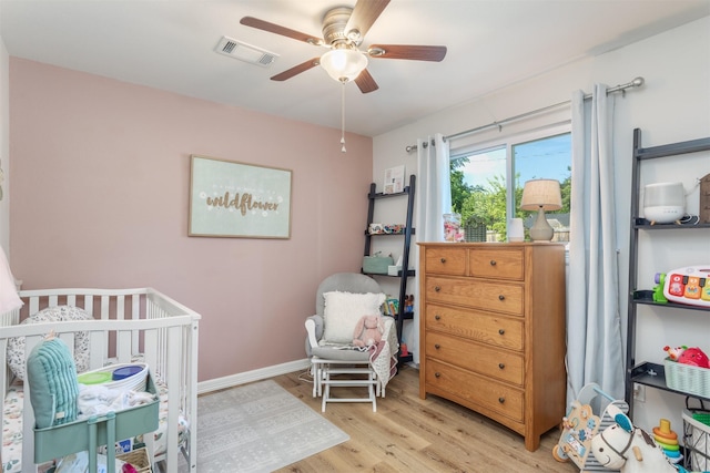 1413 White Way, Mckinney, TX 75069 - bedroom with a nursery area, light wood-style flooring, and ceiling fan