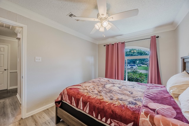 6508 Running Creek Dr, Arlington, TX 76001 - bedroom featuring ornamental molding, wood finished floors, a textured ceiling, and a ceiling fan