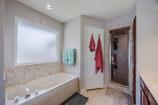 6508 Running Creek Dr, Arlington, TX 76001 - full bath with a bath, a stall shower, vanity, tile patterned floors, and a textured ceiling