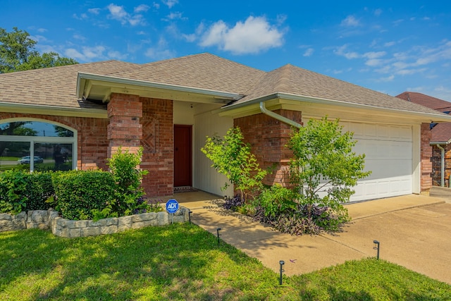 6508 Running Creek Dr, Arlington, TX 76001 - ranch-style home with brick siding, an attached garage, roof with shingles, driveway, and a front lawn