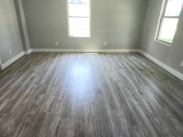 104 College St, Royse City, TX 75189 - spare room featuring dark wood-type flooring and baseboards