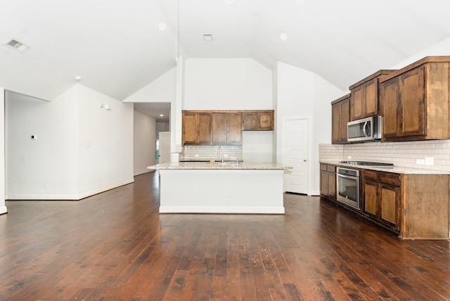 937 Nathanael Greene Ct, Aubrey, TX 76227 - kitchen with stainless steel appliances, backsplash, dark wood-style flooring, light stone counters, and high vaulted ceiling