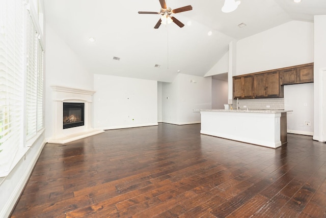 937 Nathanael Greene Ct, Aubrey, TX 76227 - unfurnished living room featuring ceiling fan, high vaulted ceiling, dark wood-style floors, a glass covered fireplace, and recessed lighting