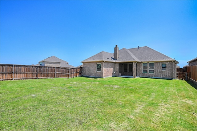 233 Cross Fox Ln, Aledo, TX 76008 - rear view of house with a fenced backyard, brick siding, and a chimney