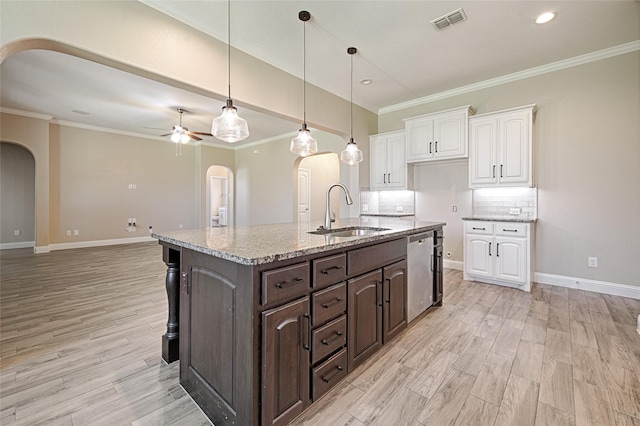 233 Cross Fox Ln, Aledo, TX 76008 - kitchen featuring arched walkways, dishwasher, white cabinetry, light wood-type flooring, and dark brown cabinets