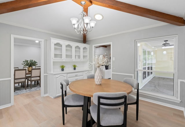 6104 Bluff Point Dr, Dallas, TX 75248 - dining space featuring a chandelier, light wood-type flooring, ornamental molding, and wainscoting