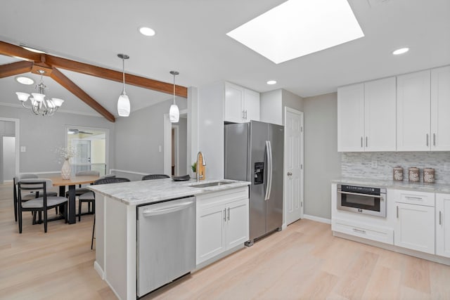 6104 Bluff Point Dr, Dallas, TX 75248 - kitchen with stainless steel appliances, light wood-style flooring, white cabinetry, decorative light fixtures, and recessed lighting