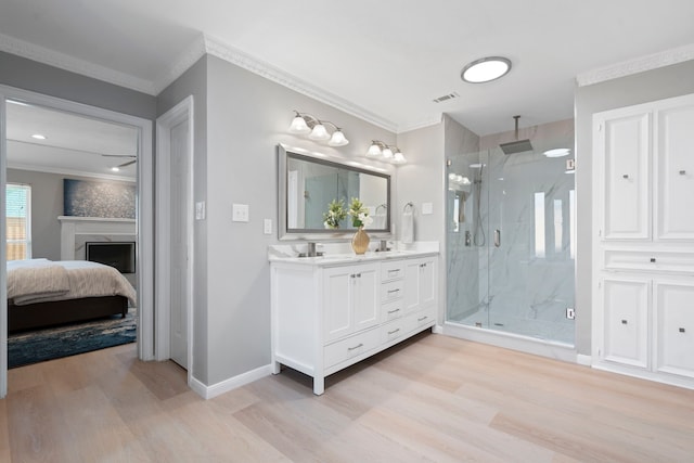 6104 Bluff Point Dr, Dallas, TX 75248 - bathroom featuring wood finished floors, a marble finish shower, crown molding, double vanity, and ensuite bathroom