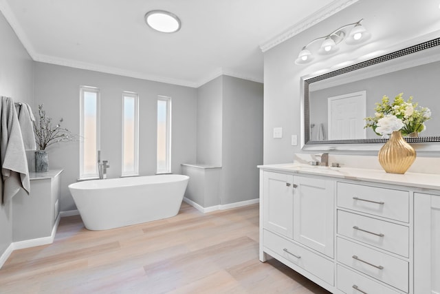 6104 Bluff Point Dr, Dallas, TX 75248 - bathroom featuring vanity, a soaking tub, wood finished floors, and crown molding
