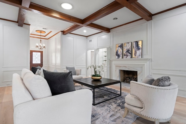 6104 Bluff Point Dr, Dallas, TX 75248 - living room with a decorative wall, a chandelier, light wood-type flooring, a premium fireplace, and beamed ceiling