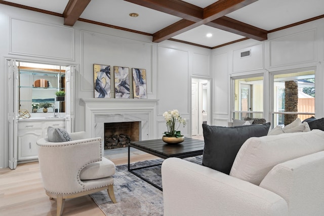 6104 Bluff Point Dr, Dallas, TX 75248 - living area with a decorative wall, light wood finished floors, beam ceiling, coffered ceiling, and a fireplace